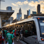 Fans boarding a light rail train at a 2026 FIFA World Cup host city stadium station